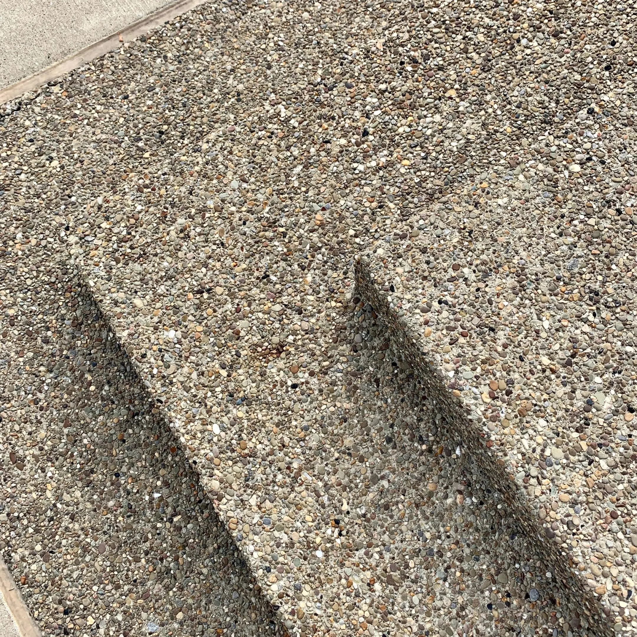 Concrete steps with exposed aggregate surface.