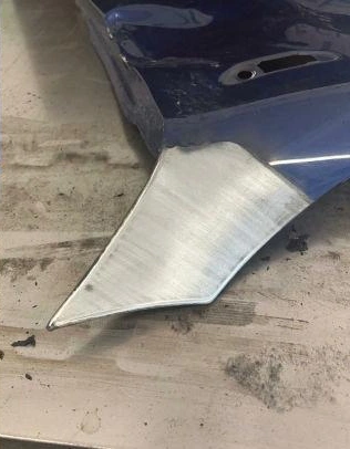 Polished metal edge on a blue object.