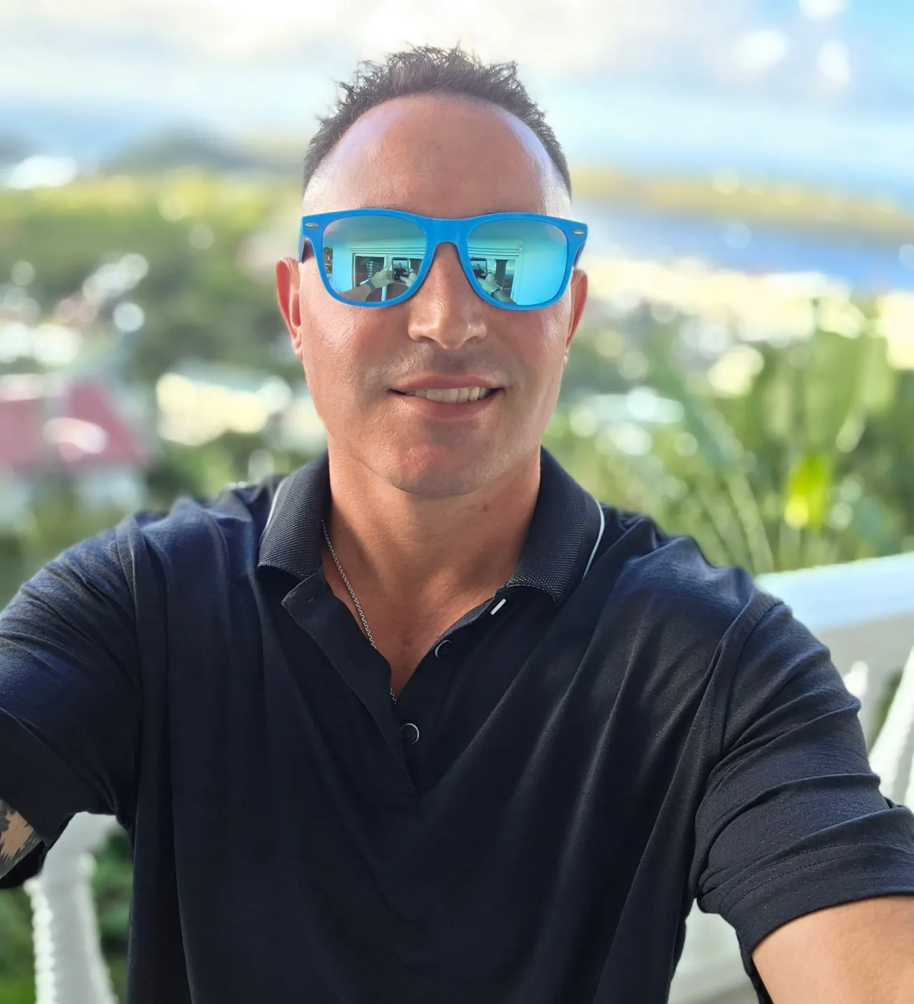 Smiling man in blue mirrored sunglasses